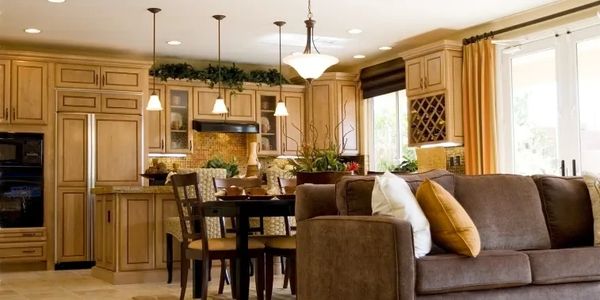 Cozy open-concept kitchen and living room with warm wood tones and natural light.