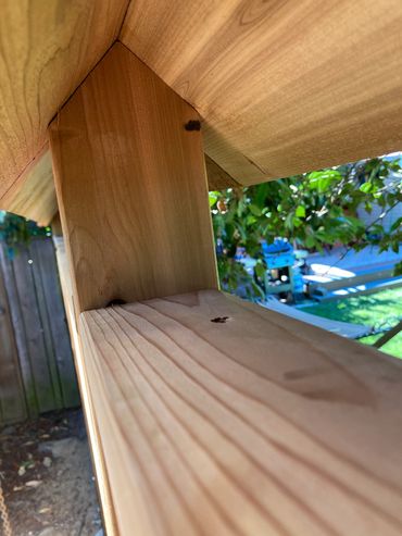 This image shows under the pitched roof of the overlap privacy fence with a top cap board. 