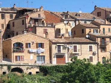 Historic Italian hillside village buildings.
