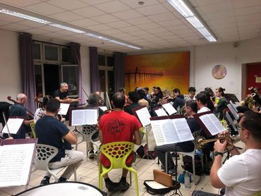 Large orchestra practicing in studio.