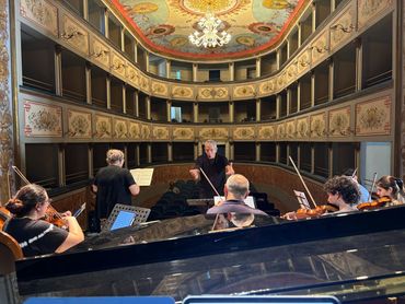 Musicians practicing in tiered theater.