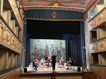 Performance on stage with backdrop.