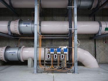 Industrial photo of large pipes underground at a water treatment plant.