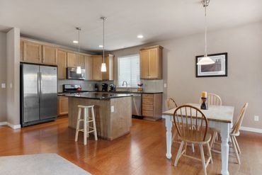 Interior real estate photo of modern kitchen with open floor plan