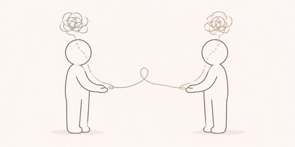 Two figures with tangled thoughts connected by a string.