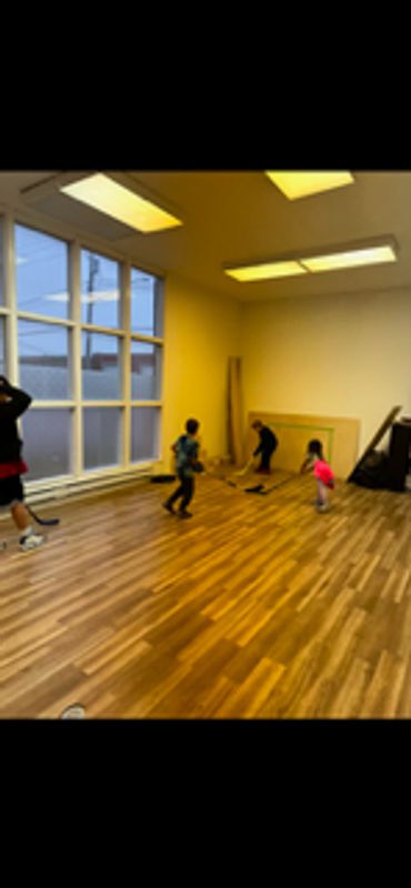 Children learning basic ball hockey techniques