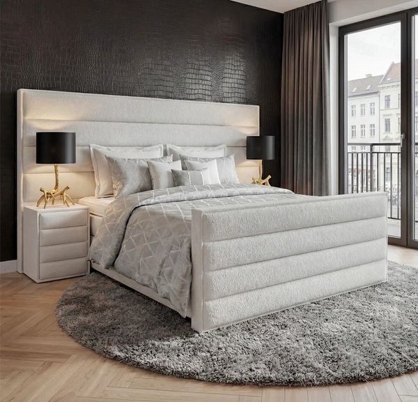 Modern bedroom with a plush white bed and black accents.