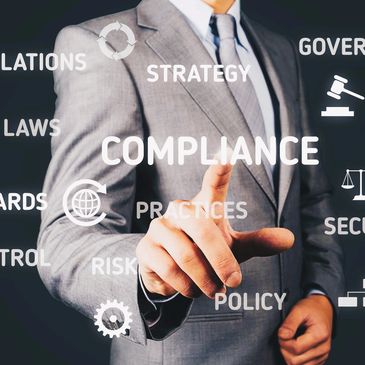 Business person selecting words such as "compliance", "standards" and "governance".