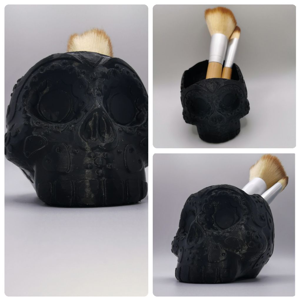 Black skull-shaped brush holder with makeup brushes.