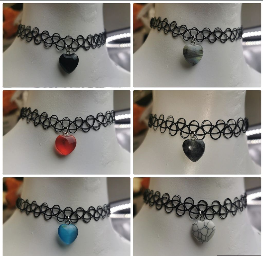 Six black chokers with different heart-shaped pendants.