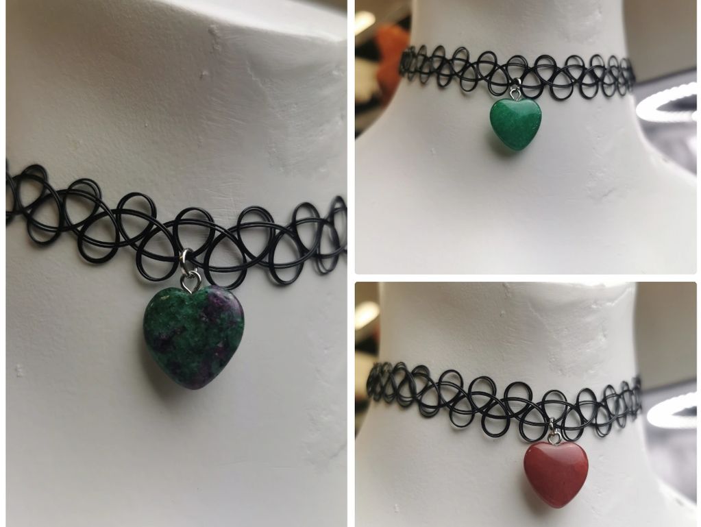 Three black choker necklaces with heart-shaped stone pendants in green, red, and mixed colors.
