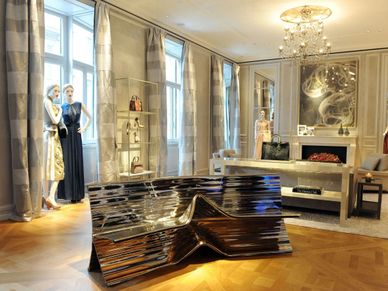 Luxurious living room with modern metallic sofa and elegant decor.