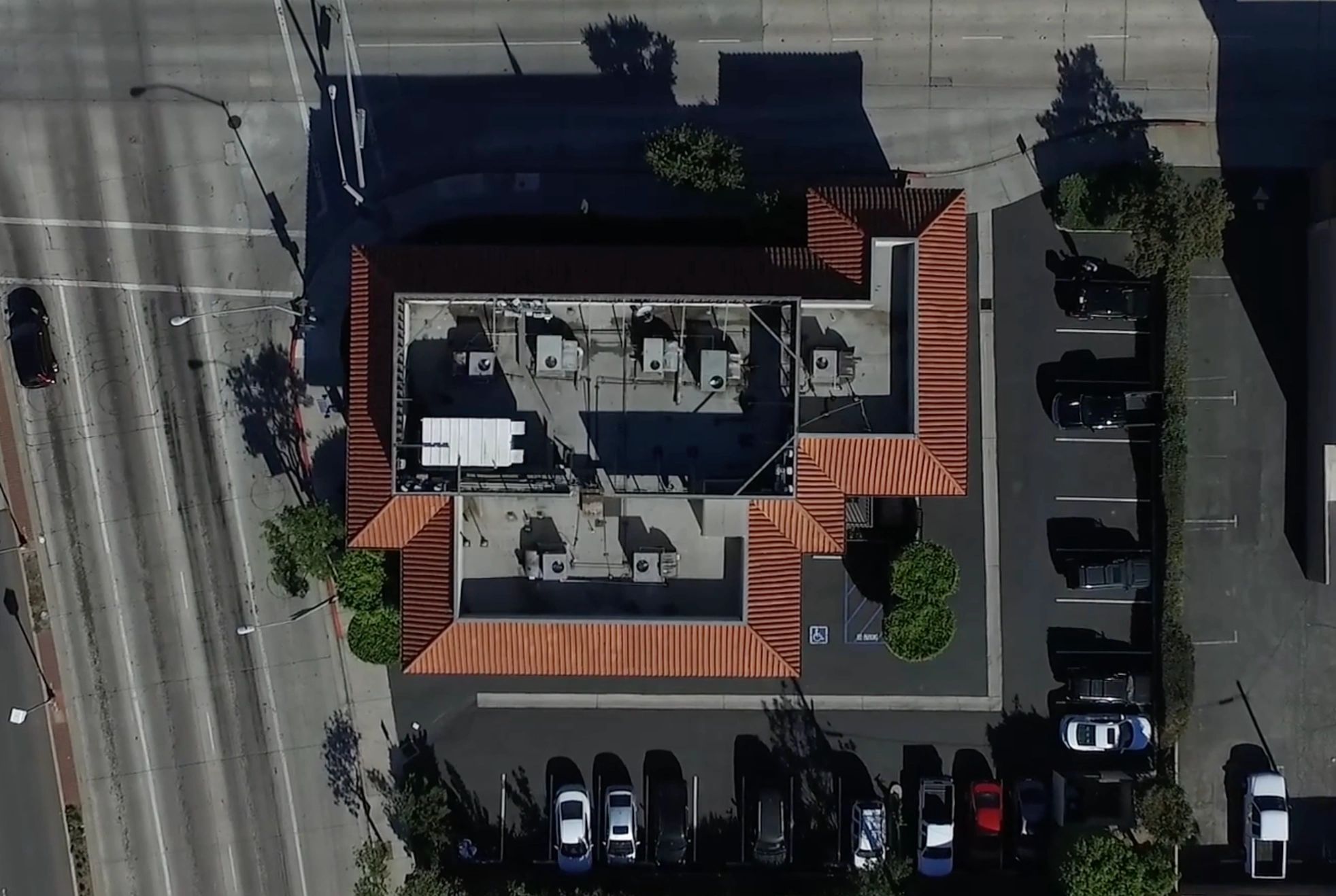 Rooftop cell tower installation with multiple 5G antennas and supporting equipment.