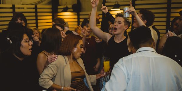 People enjoying a lively party with dancing and drinks.