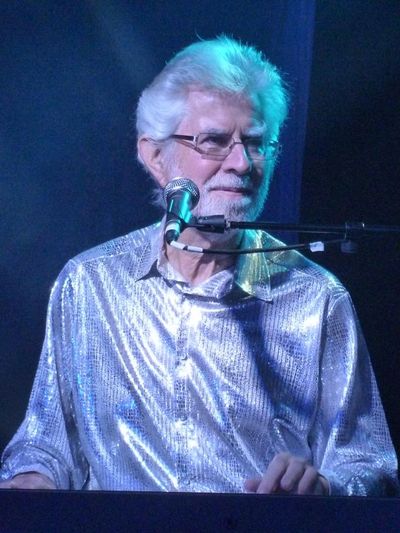 Portrait shot of Bob Hall playing the piano on stage