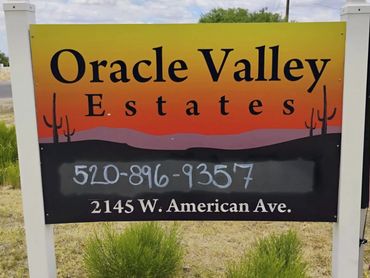 Sign for Oracle Valley Estates with contact info and address.