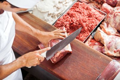 Butcher cutting meat
