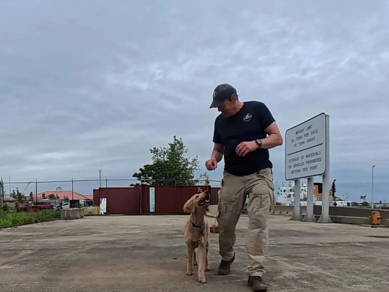 Robin Stenhouse practising leash handling with a dog outdoors.
