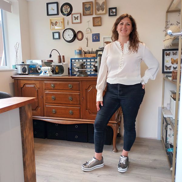 a smiling woman wearing a white shirt.