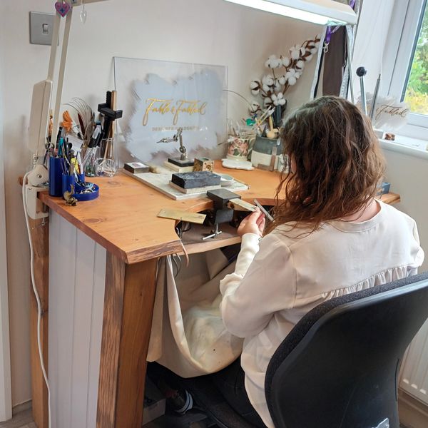 a woman creating jewelry.