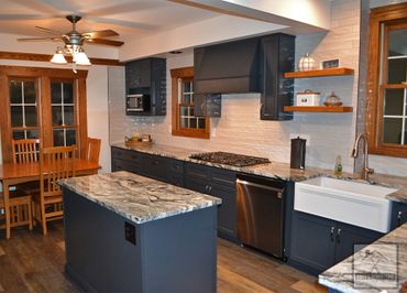 Full kitchen remodel with custom cabinets, countertops, island, backsplash, and vinyl plank flooring