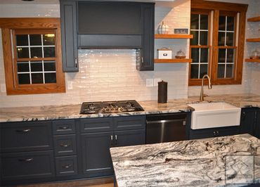 Custom cabinets, island, backsplash, built in range.