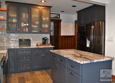 Full kitchen remodel with custom cabinets, island, vinyl plank flooring, and custom countertops