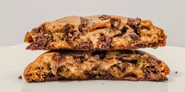 Close-up of a chocolate chip cookie broken in half.