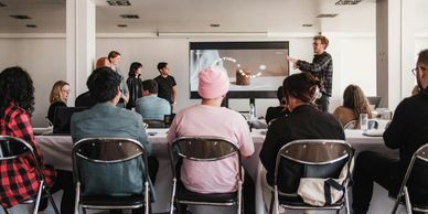 A group attending a presentation in a modern conference room.