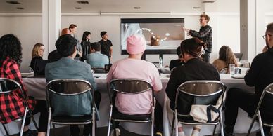 A group attending a presentation in a modern conference room.