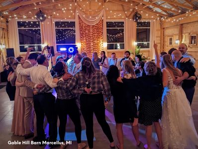 Group dancing at the Gable Hill Barn Venue Marcellus, MI Bride & Groom with their friends and family