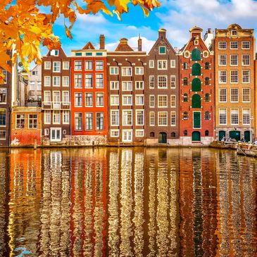 Netherlands, buildings reflected in river aboard Viking river cruises