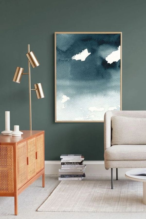 Indigo blue watercolour painting of a misty lake shown framed in a room with furniture by Renée Anne