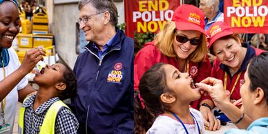 Volunteers administer oral polio vaccines to children during a global health campaign.