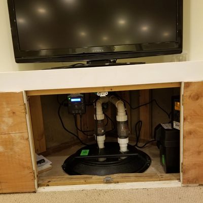 Sump pump custom installation under TV
