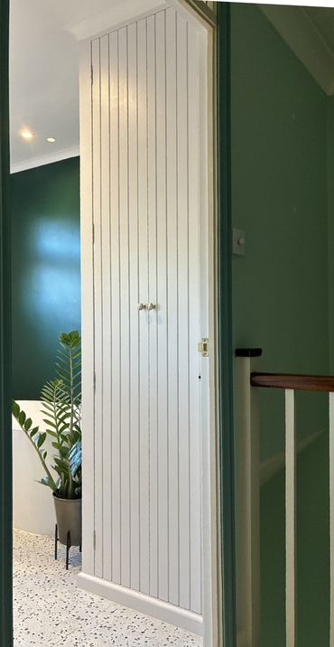 Custom made cupboard above stairs