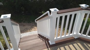 Darker border accents deck and steps, solar powered lights powering up