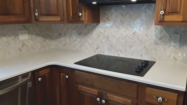 Herringbone Marble Backsplash with Matching Quartz Countertop