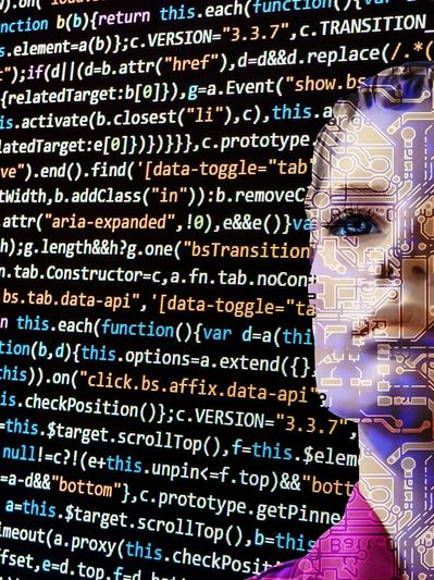 A woman's face is displayed on the computer through coding.