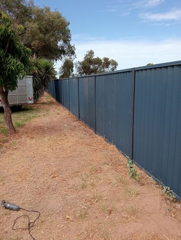Repaired blue colorbond fence
