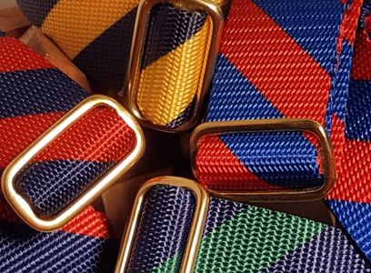 Bowtie Belts belt made of webbing and a brass slide in bold stripe patterns