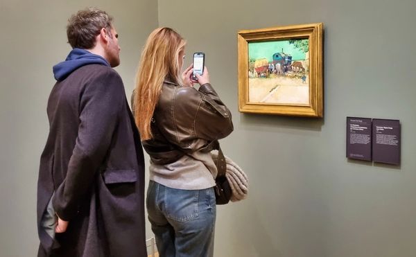 Two Visitors in Musée D'Orsay Van Gogh Les Roulottes, camp bohemiens Arles 1888