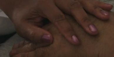 Two hands with nails gently touching a person's skin.