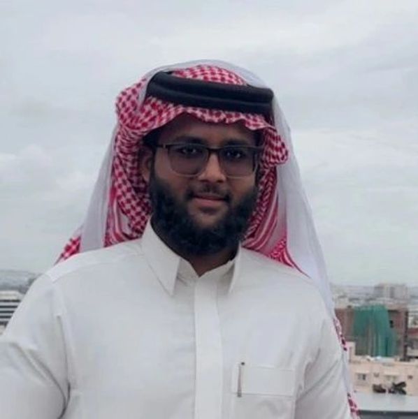 Man wearing traditional Middle Eastern attire with glasses.