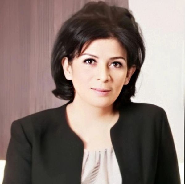 Professional woman with black hair wearing a black blazer.