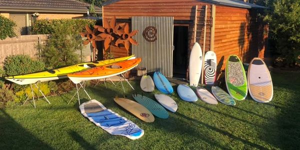 Kayaks, Surfboards, stand up paddleboards and foilboards await repairs in Canberra.
