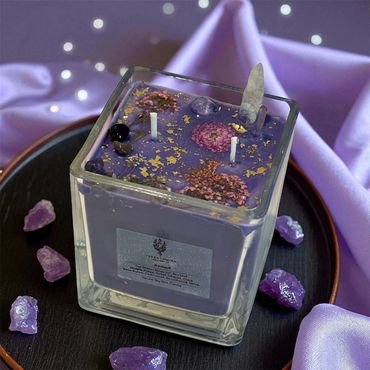 10 oz Nomad candle adorned with dried flowers, gold leaf, clear quartz, and amethyst crystals.