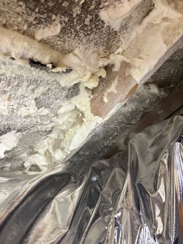 spray foam hidden under a foil blanket
