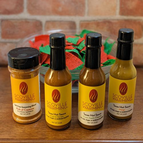 Three bottles of Scoville Warming Texas Hot Sauce and one bottle of Kick of Cayenne Seasoning