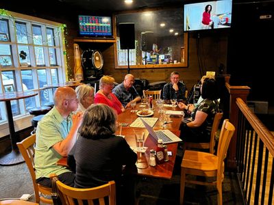 Group of people having a meeting around a table in a cozy room.